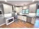 Modern kitchen with white cabinets, stainless steel appliances, granite countertops, and hardwood floors at 7823 Ashtree Dr, Indianapolis, IN 46259
