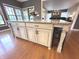 Close-up of kitchen island featuring granite counters, seating for four, and views of the backyard at 7823 Ashtree Dr, Indianapolis, IN 46259