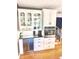 This kitchen features white cabinets, glass display cases, a wine cooler, and stainless steel appliances at 7823 Ashtree Dr, Indianapolis, IN 46259