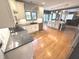Open-concept kitchen with a spacious island, stainless steel appliances, and hardwood floors at 7823 Ashtree Dr, Indianapolis, IN 46259