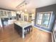 Open-concept kitchen boasts a large island, stainless steel appliances, and custom cabinetry for storage at 7823 Ashtree Dr, Indianapolis, IN 46259