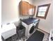 Efficient laundry room with washer, dryer, sink, and cabinet storage for household needs at 7823 Ashtree Dr, Indianapolis, IN 46259