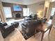 Inviting living room with stone fireplace, wood-paneled accent wall, and comfortable leather seating at 7823 Ashtree Dr, Indianapolis, IN 46259