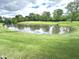 Scenic view of a private pond, enhancing the property's natural beauty and providing a tranquil retreat at 7823 Ashtree Dr, Indianapolis, IN 46259