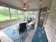 Relaxing screened porch offers a ceiling fan, comfortable seating, and views of the landscaped backyard at 7823 Ashtree Dr, Indianapolis, IN 46259