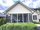 Cozy screened porch featuring comfortable seating and serene views of the lush backyard at 7823 Ashtree Dr, Indianapolis, IN 46259