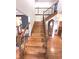 Elegant staircase with wood treads, wrought iron spindles, and access to the upper level of the home at 7823 Ashtree Dr, Indianapolis, IN 46259