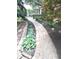 Charming brick walkway surrounded by beautifully landscaped garden beds and lush greenery at 7823 Ashtree Dr, Indianapolis, IN 46259