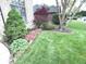 Beautiful yard featuring mature landscaping with trees, flowering plants, and a well-maintained lawn at 7823 Ashtree Dr, Indianapolis, IN 46259