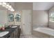 Main bathroom with dual vanity, soaking tub, and modern finishes at 8376 Glen Highlands Dr, Indianapolis, IN 46236
