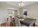Open dining area features hardwood floors, stylish seating, and natural light from a bay window at 8376 Glen Highlands Dr, Indianapolis, IN 46236