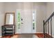 Bright foyer with hardwood floors, white door with sidelights, and a stylish accent table at 8376 Glen Highlands Dr, Indianapolis, IN 46236