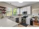 Bright kitchen features white cabinets, stainless steel appliances, and plenty of natural light at 8376 Glen Highlands Dr, Indianapolis, IN 46236