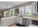 Bright kitchen featuring white cabinetry, stainless steel appliances, and views of the backyard at 8376 Glen Highlands Dr, Indianapolis, IN 46236