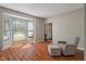 Inviting living room features a large bay window, hardwood flooring, and a comfortable chair and ottoman at 8376 Glen Highlands Dr, Indianapolis, IN 46236