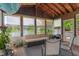 Inviting sunroom overlooking serene lake with comfortable seating and natural light at 8376 Glen Highlands Dr, Indianapolis, IN 46236