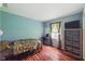 Bedroom featuring blue walls, wood floor and curtains at 9130 E 18Th St, Indianapolis, IN 46229