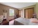 Bedroom features a plush bed, hardwood floors, and natural light from a window at 9130 E 18Th St, Indianapolis, IN 46229