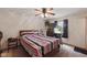 Bedroom features a ceiling fan and a large window providing natural light at 9130 E 18Th St, Indianapolis, IN 46229