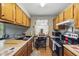 Functional kitchen featuring wooden cabinets, modern appliances, and ample counter space, ideal for meal preparation at 9130 E 18Th St, Indianapolis, IN 46229