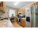 Clean kitchen with stainless steel appliances, wooden cabinets, ample counter space, and a view of the backyard at 9130 E 18Th St, Indianapolis, IN 46229