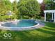 Inviting backyard pool with lush greenery and comfortable lounge area at 9510 Copley Dr, Indianapolis, IN 46260