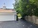 Attached garage with a weathervane and a driveway leading to a gated entrance at 9510 Copley Dr, Indianapolis, IN 46260
