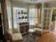 Charming living area with patterned chairs, a glass table, and elegant decor details at 9510 Copley Dr, Indianapolis, IN 46260