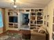 Living room with custom built-in shelving and hardwood floors at 9510 Copley Dr, Indianapolis, IN 46260