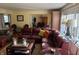 Open-concept living room with leather sectional sofa and adjacent dining area at 9510 Copley Dr, Indianapolis, IN 46260
