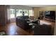 Spacious living room with hardwood floors, large windows, and a comfortable leather sofa at 9510 Copley Dr, Indianapolis, IN 46260