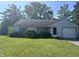 Charming single-story home with a well-maintained lawn, attached garage, and mature landscaping at 9533 Burrwood Ct, Indianapolis, IN 46235