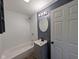 Bright bathroom featuring a modern tub and vanity, as well as wood-look floors at 9712 N Price St, Knightsville, IN 47857