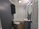Clean bathroom with white toilet and tub, and a modern gray vanity and faucet at 9712 N Price St, Knightsville, IN 47857