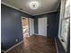 Cozy bedroom with wood-look floors, neutral walls and bright natural light from the window at 9712 N Price St, Knightsville, IN 47857
