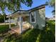 Charming cottage-style home with a covered porch and a well-maintained lawn at 9712 N Price St, Knightsville, IN 47857