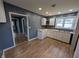 Well-lit kitchen featuring butcher block countertops, white cabinetry, and modern flooring at 9712 N Price St, Knightsville, IN 47857