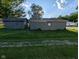 Exterior view of a home's outbuildings, showing aged siding and yard at 9712 N Price St, Knightsville, IN 47857