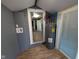 Utility room features hot water heater, various plumbing, and access to other rooms and the exterior at 9712 N Price St, Knightsville, IN 47857