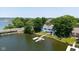 Expansive lakefront property with a private dock, lush greenery, and a charming two-story home at 101 Edgewater Dr, Noblesville, IN 46062