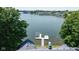 Picturesque lake view of a waterfront property featuring a private dock with a boat lift and scenic surroundings at 101 Edgewater Dr, Noblesville, IN 46062