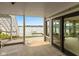Outdoor patio with lake view, steps to upper level, and glass doors into sunroom at 101 Edgewater Dr, Noblesville, IN 46062
