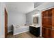 Bathroom featuring a soaking tub, vanity and dark wood accents at 101 Edgewater Dr, Noblesville, IN 46062