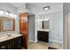 Bathroom with double sinks, warm toned cabinets, and well lit vanity lighting at 101 Edgewater Dr, Noblesville, IN 46062