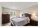 Cozy bedroom with a comfortable bed, a window and dark wood dresser and nightstands at 101 Edgewater Dr, Noblesville, IN 46062