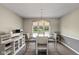 Bright dining room features a round glass table, modern lighting, and a buffet with storage at 101 Edgewater Dr, Noblesville, IN 46062