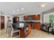 Spacious kitchen with dark wood cabinets, granite countertops, stainless appliances, and island seating at 101 Edgewater Dr, Noblesville, IN 46062