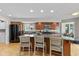 Bright kitchen with stainless steel appliances, dark wood cabinetry, and a large center island with bar seating at 101 Edgewater Dr, Noblesville, IN 46062