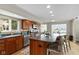 Well-lit kitchen with cherry cabinets, island with seating and stainless steel appliances at 101 Edgewater Dr, Noblesville, IN 46062