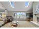 Bright living room with a fireplace, a large window, and a vaulted ceiling with skylights at 101 Edgewater Dr, Noblesville, IN 46062